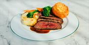 Plate of beef, vegetables, potatoes and Yorkshire pudding served at Haslem Kitchen