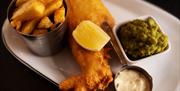 Plate of fish, chips, mushy peas, tartare sauce and lemon served at Haslem Kitchen