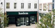 Shot of exterior of Haslem Hotel in corner Lisburn Square with trees to either side