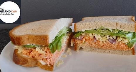 Image shows two sandwiches with a variety of fillings.