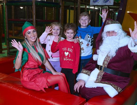 Picture of Children in soft play area beside Santa Claus and elf