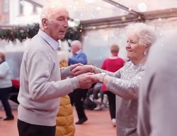 Picture of two people dancing together.