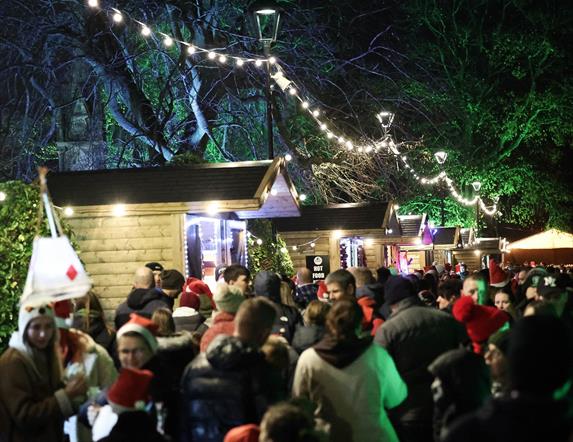 Image is of people enjoying the Christmas Market in Lisburn