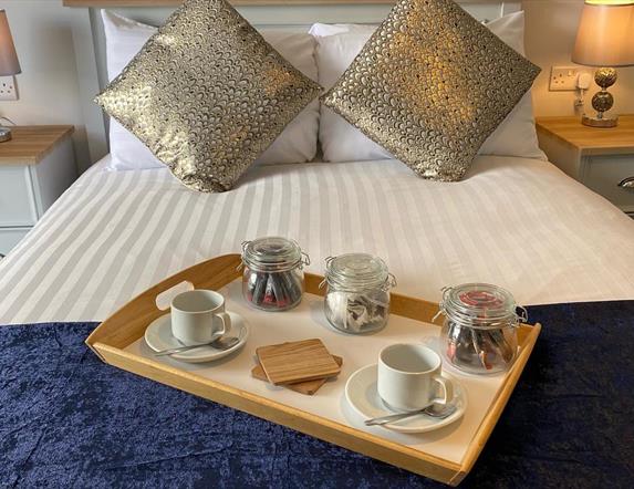 Image show breakfast tray on double bed in guest room