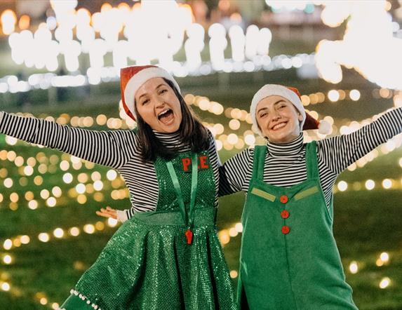 Image is of 2 girls dressed as Elves re the Elfie Tour