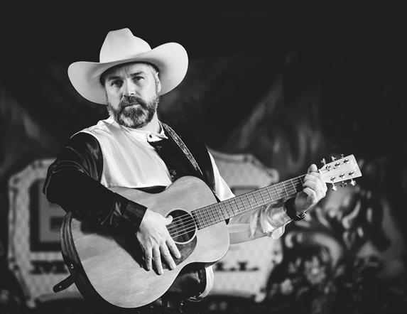 Image is of Garth Brooks Tribute act on stage with his guitar