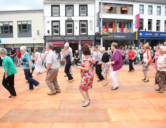 Dancers dancing on wooden floor in Market Square, Lisburn