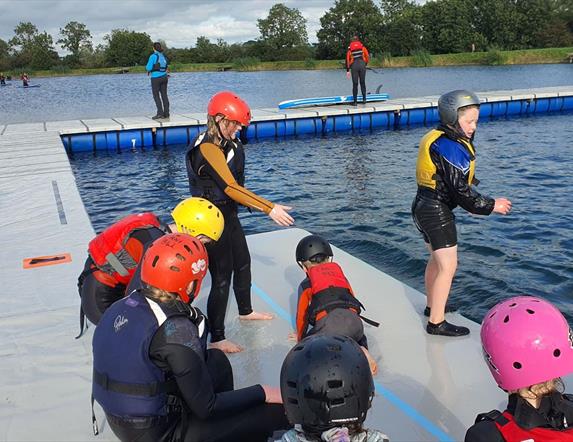 Image is of children preparing to paddle at Moira Lakes