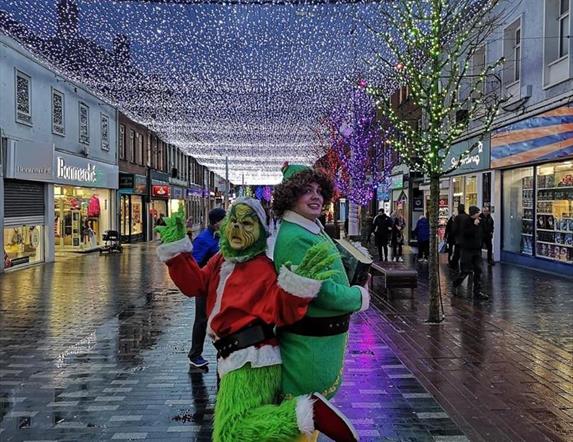 Image is various Christmas characters on a walkabout around Lisburn