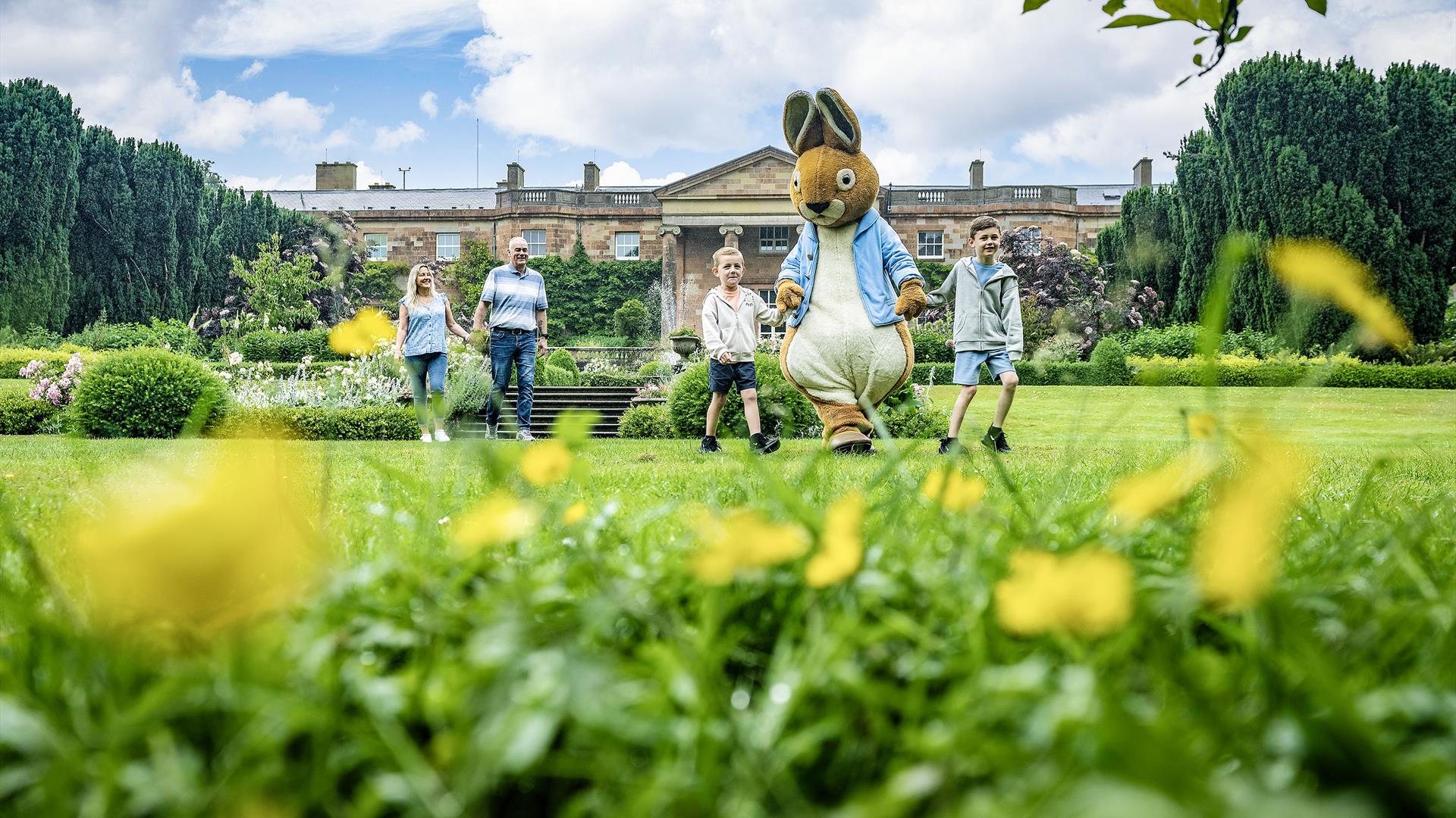 Peter Rabbit with a family in front of Hillsborough Castle