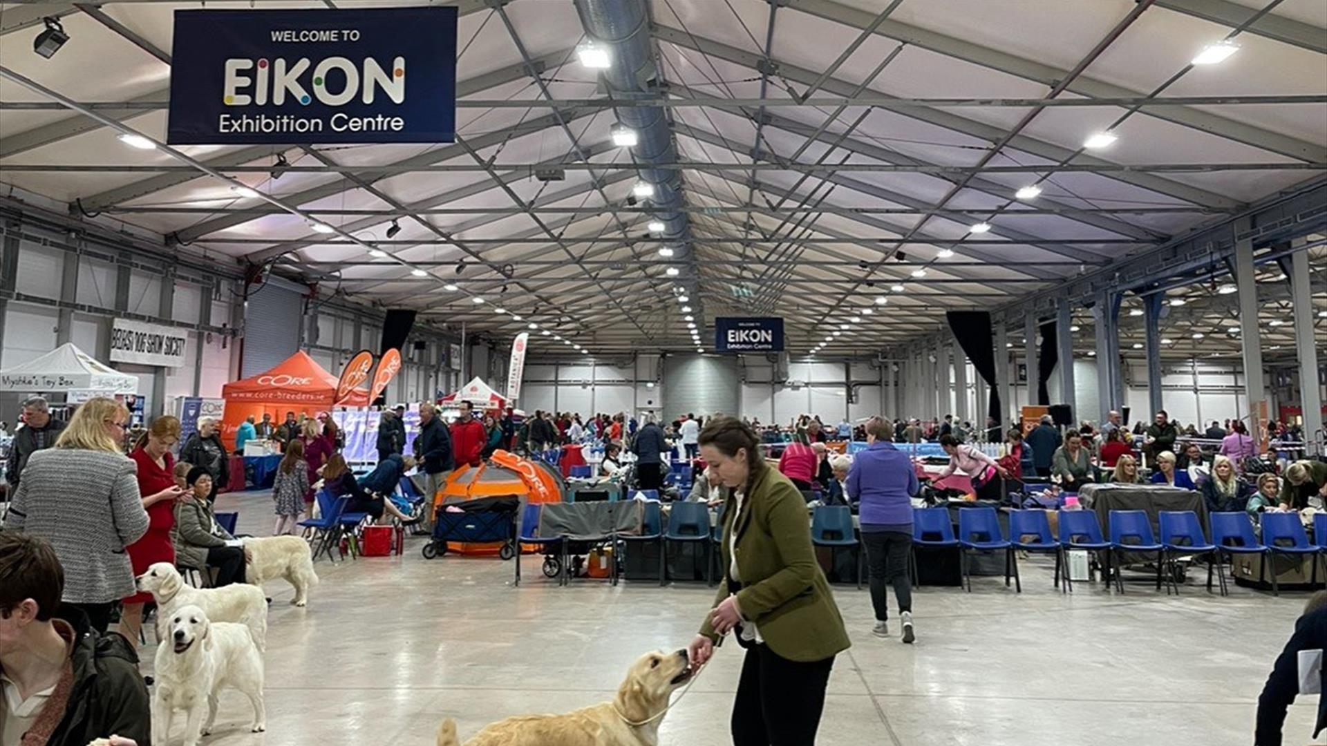 Image is of dogs and owners in the Eikon 
Exhibition Centre dog show