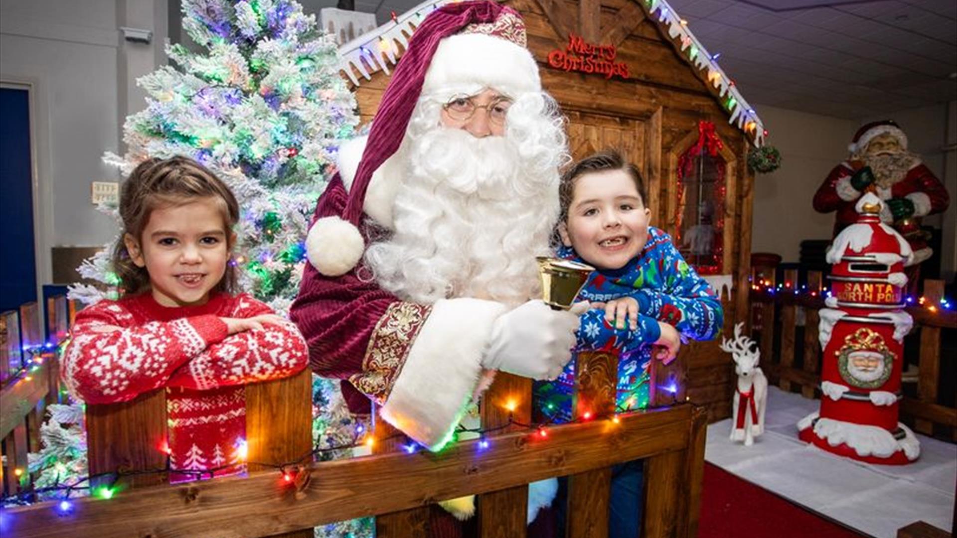 Image is of Santa Claus and children at his grotto