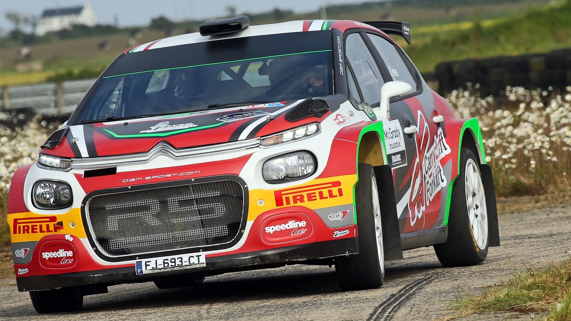 Rally Car on road at Down Rally with flowers in background