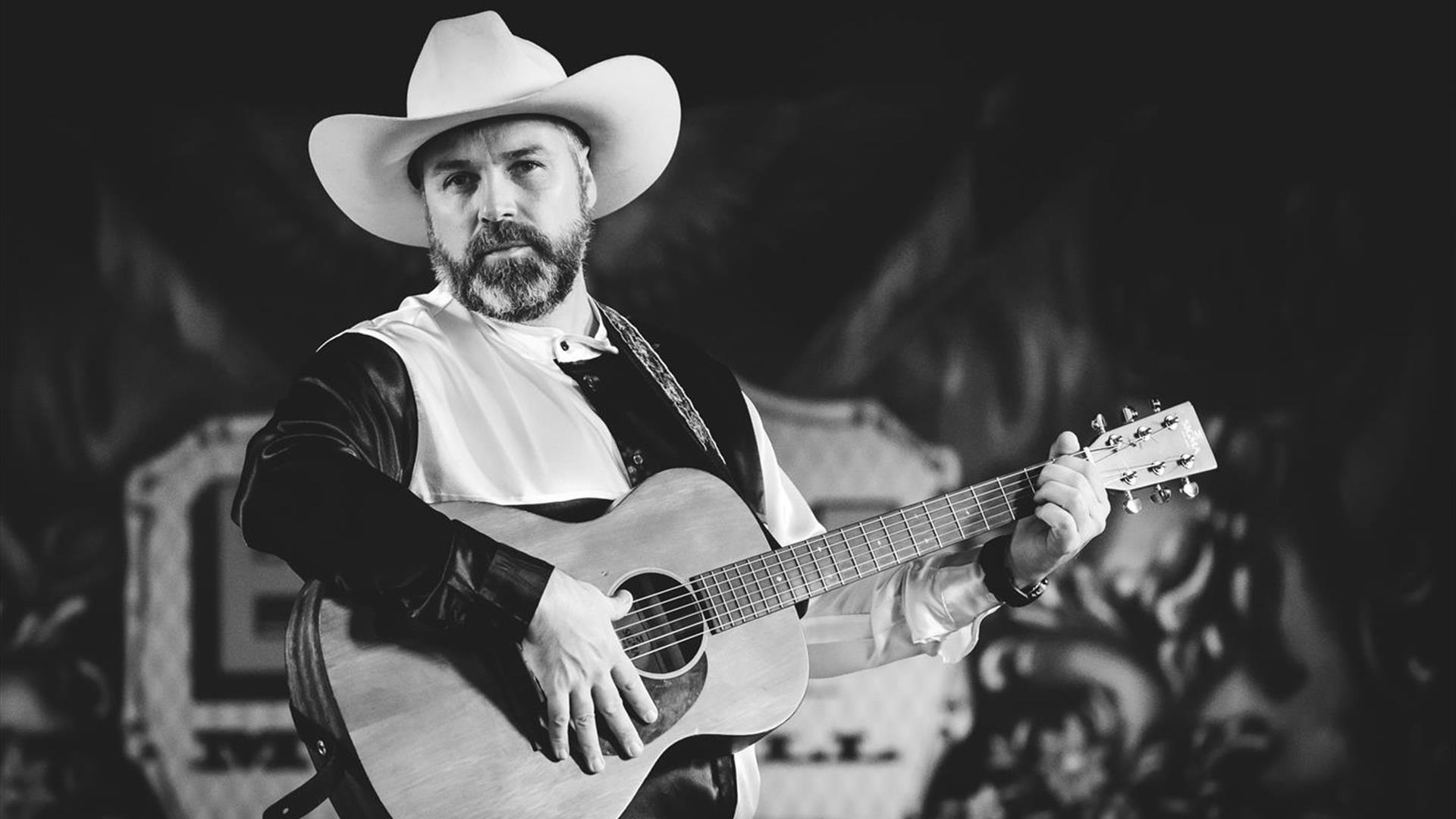 Image is of Garth Brooks Tribute act on stage with his guitar