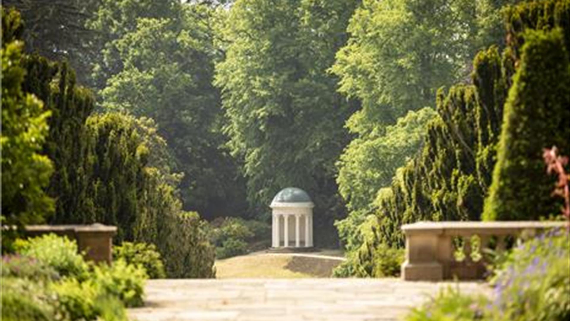 Image of gardens with trees and Lady Alice's Temple in the background