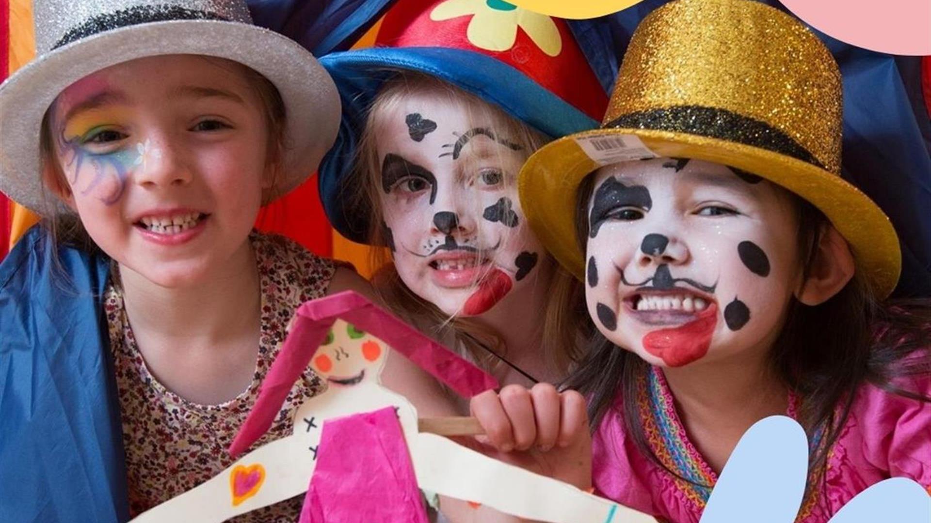 Three children dressed up in fancy dress and their faces are painted