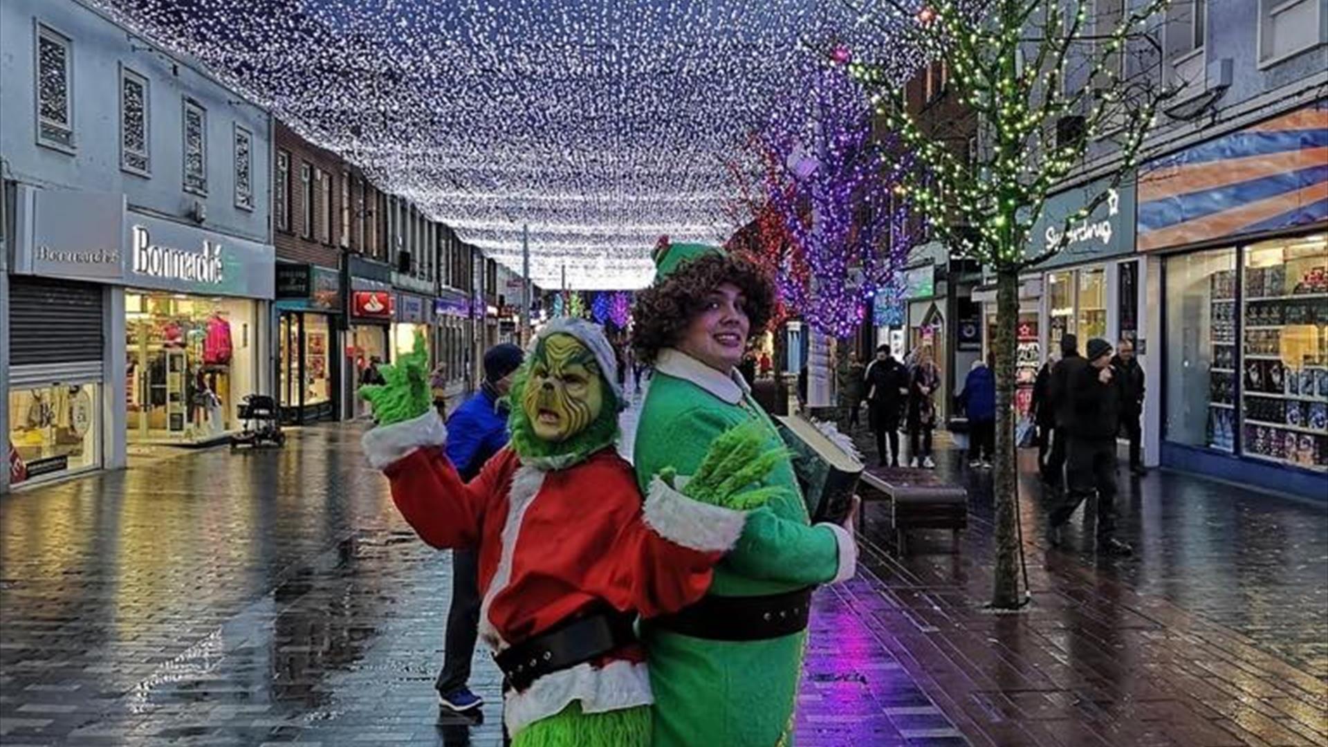 Image is various Christmas characters on a walkabout around Lisburn