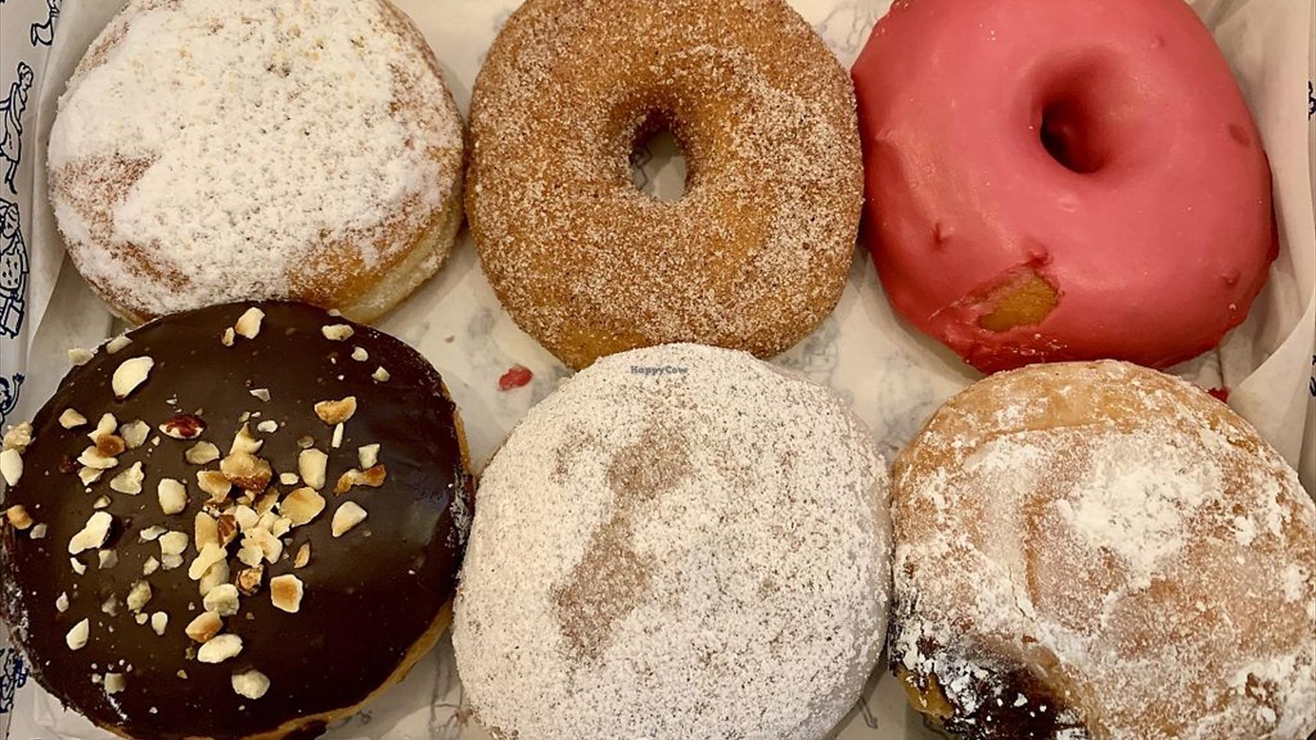 Image shows a box of 6 different donuts