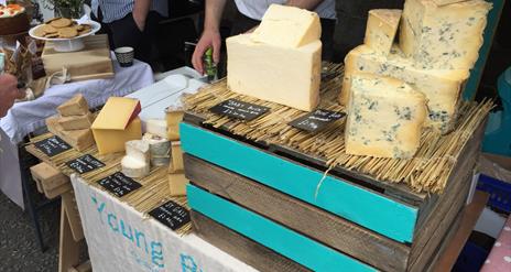 Image shows a stall showing a selection of cheese