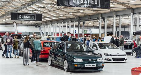 Image is of range of cars at the Dubshed event