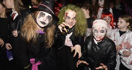 Image shows children dressed up for Halloween celebrations