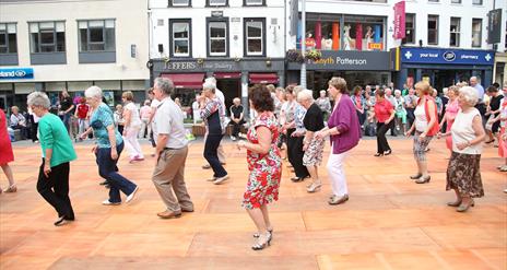 Dancers dancing on wooden floor in Market Square, Lisburn