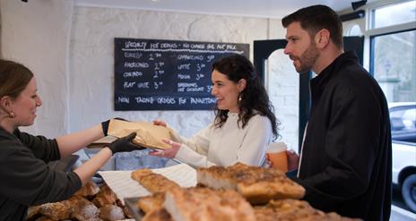 Couple at counter in Roundhouse Bakery