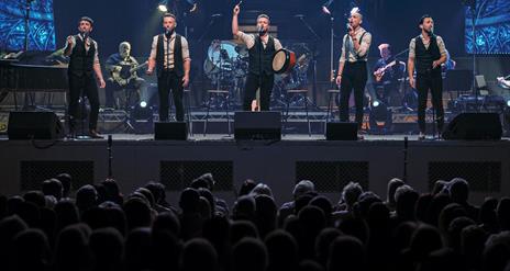 Image is of the members of the Shamrock Tenors on stage