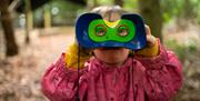 Child viewing through binoculars