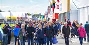 Image is of visitors walking around the Balmoral Show in Lisburn