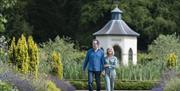 A couple stroll through the grounds of Hillsborough Castle and Gardens