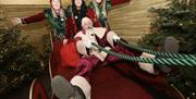 Picture of a Santa on a Sleigh with 3 elves