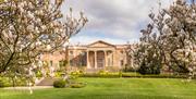 Back view of Hillsborough Castle with trees in bloom