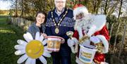 Picture of Mayor with Santa with fund raising buckets