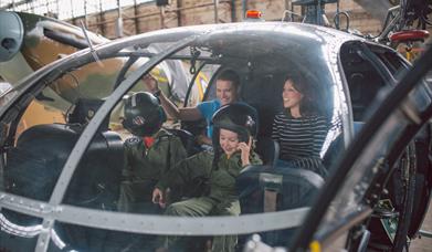 Family in cock pit of helicopter