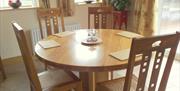 Image shows round dining table and 4 chairs