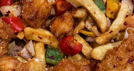 A meal including chicken and peppers with chips from the Chip Hawker