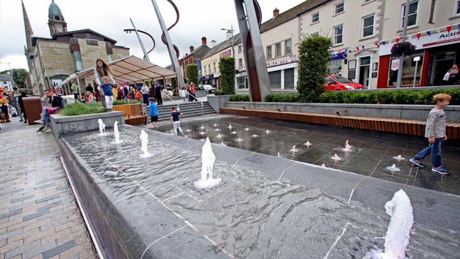 The fountains in Market Square with the Irish Linen Centre & Lisburn Museum in the background