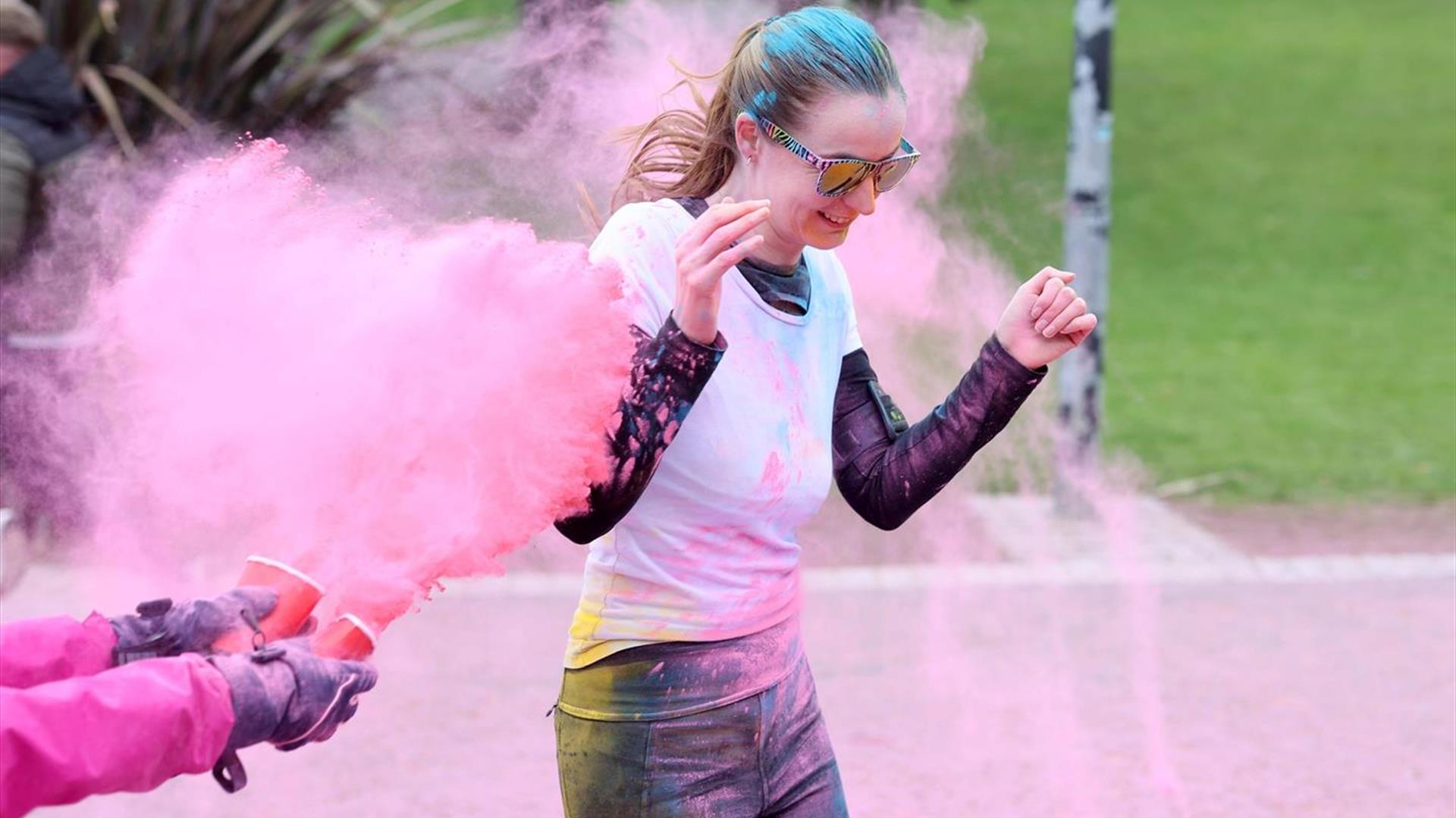 Picture of a running being being colour bombed Picture of a running being being colour bombed