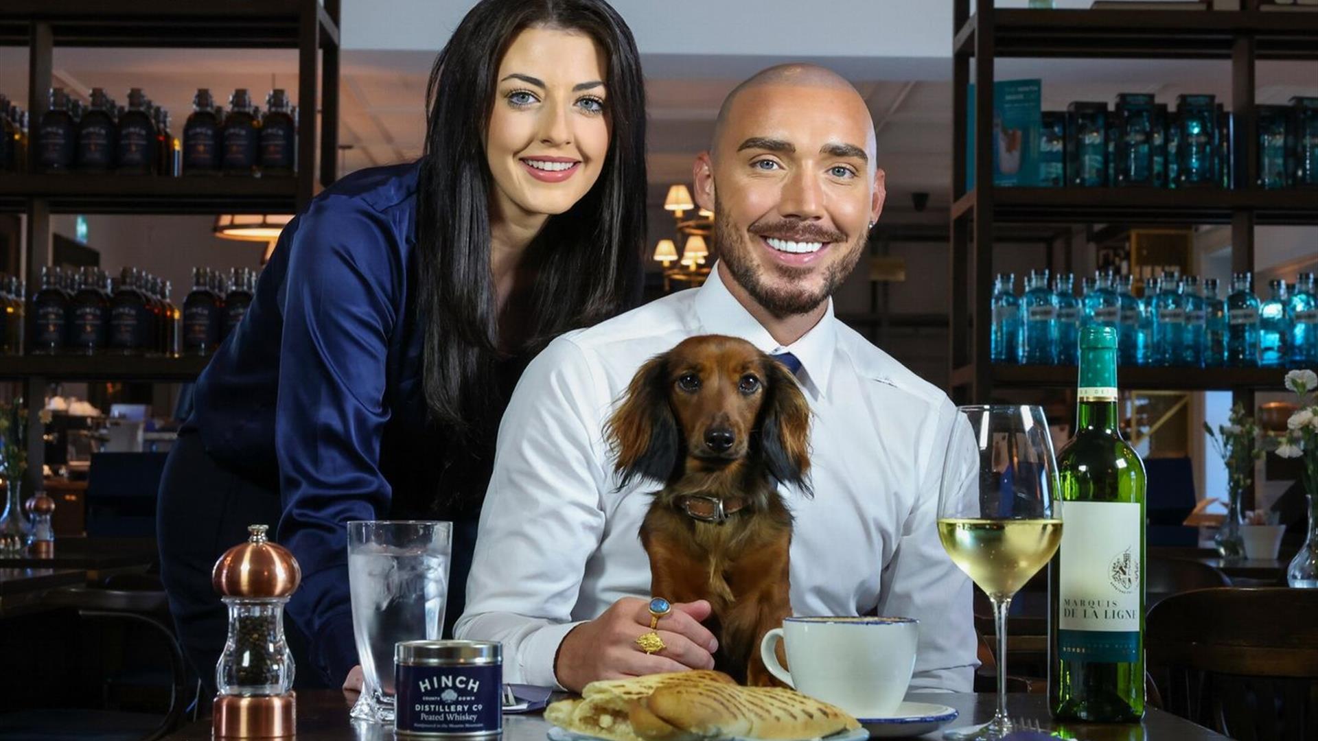 An image of Hinch Cafe with two customers enjoying the food and drink with a dachshund