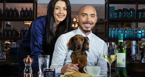An image of Hinch Cafe with two customers enjoying the food and drink with a dachshund